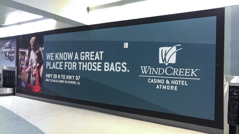 Pensacola International Airport baggage claim billboard wrap - Pensacola Sign Environmental Graphics 