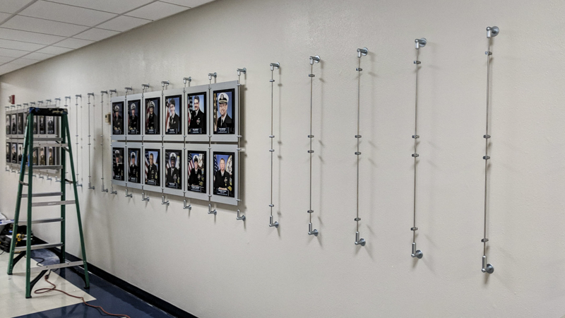 Custom built hanging hallway photo display for Naval Hospital Pensacola by Pensacola Sign