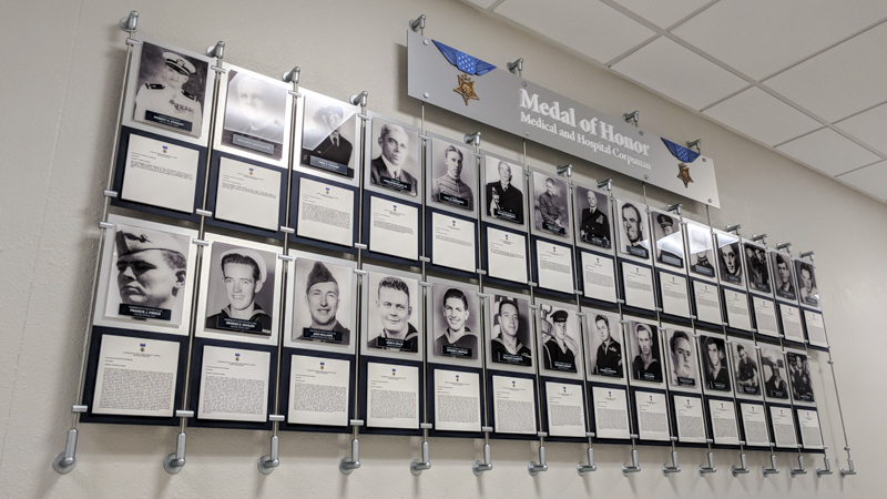 Custom built hanging hallway photo display for Naval Hospital Pensacola by Pensacola Sign